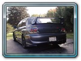 Rear end of the car showing the APR diffuser, custom tow hook, exhaust and side skirt extensions. Current Vehicle State.